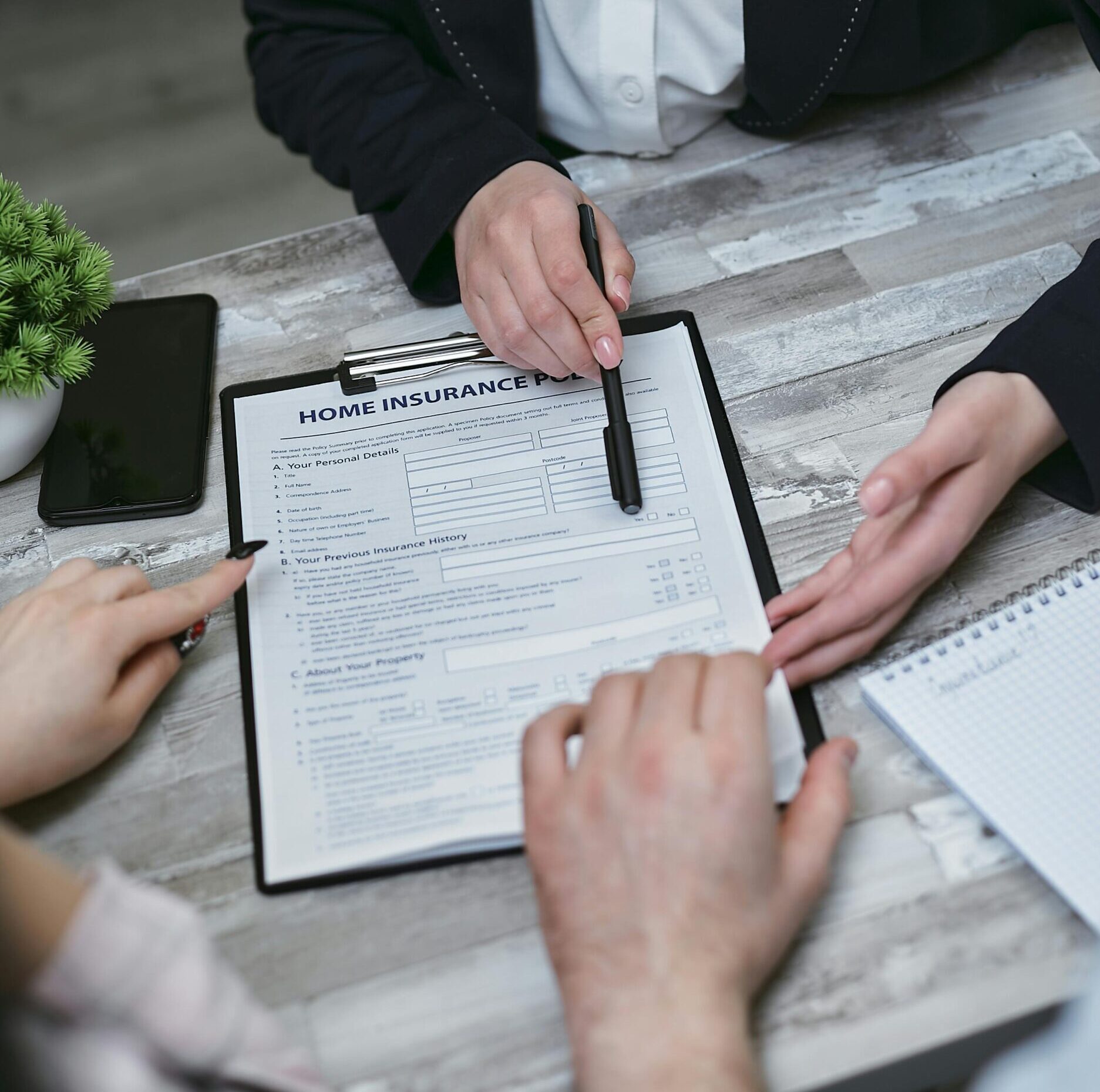 A policyholder reviews insurance documents while preparing to challenge an insurer’s decision.