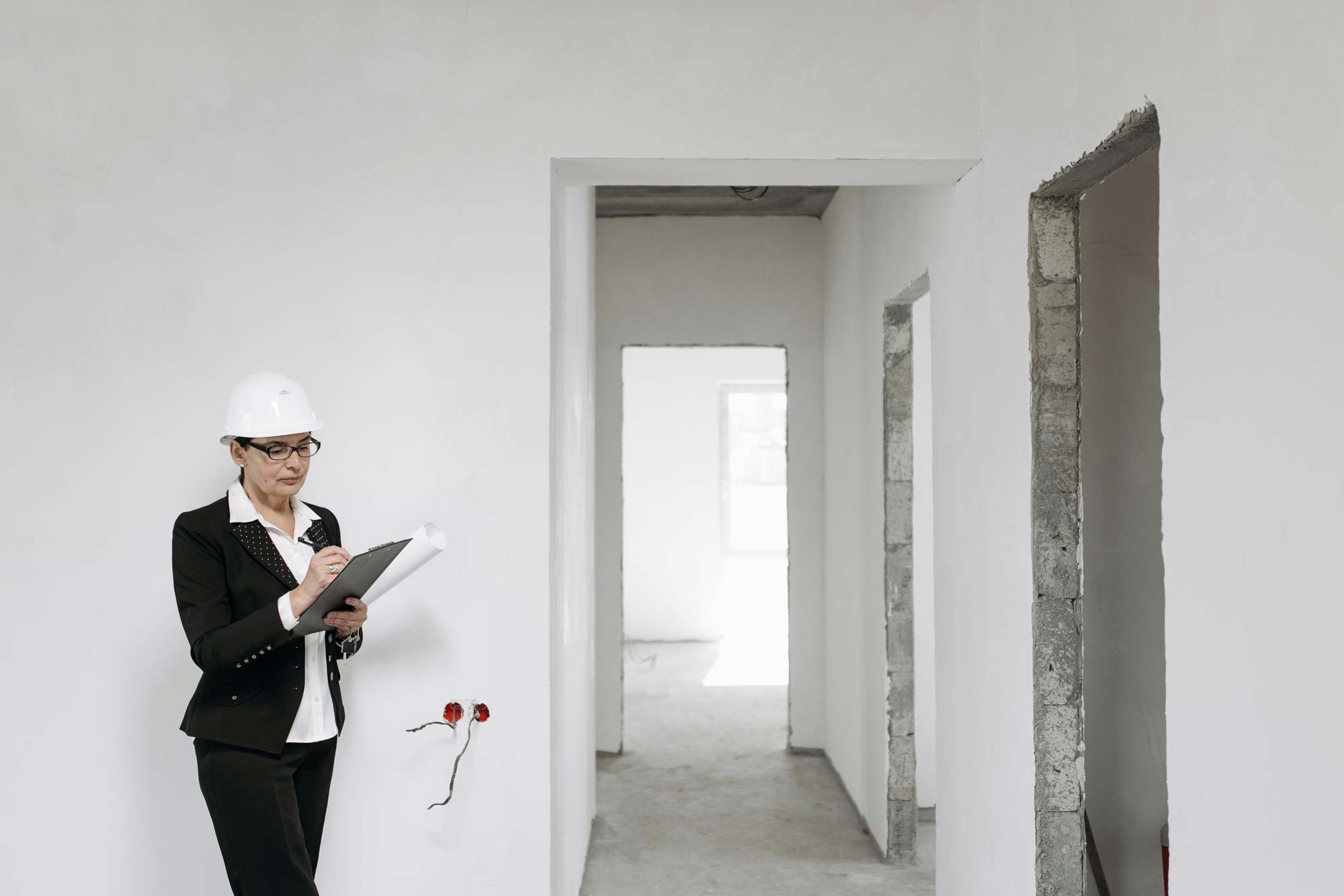 A woman completing a survey in an empty home.